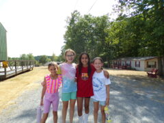 Four camp friends prepared with summer camp essentials