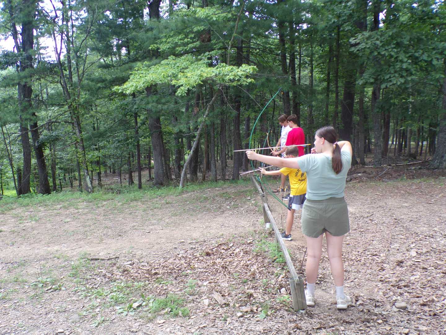 Camp Tall Timbers campers learning archery