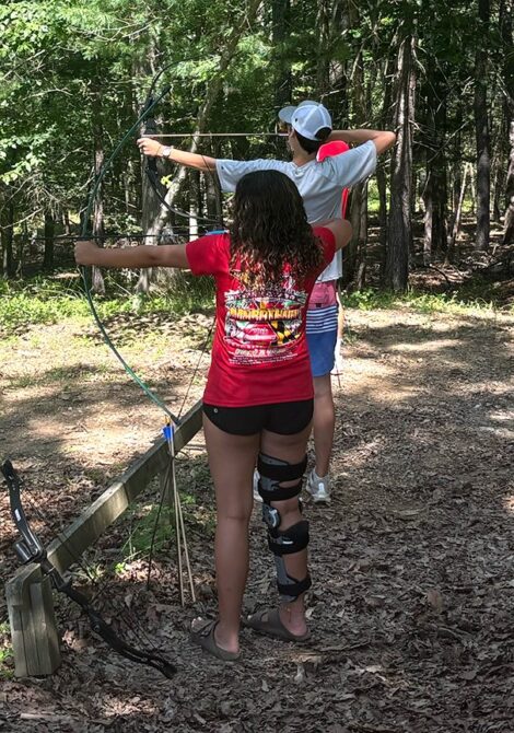 Campers shooting bows on the archery range