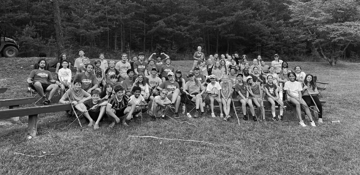 Black and white group photo of campers and staff at Camp Tall Timbers.