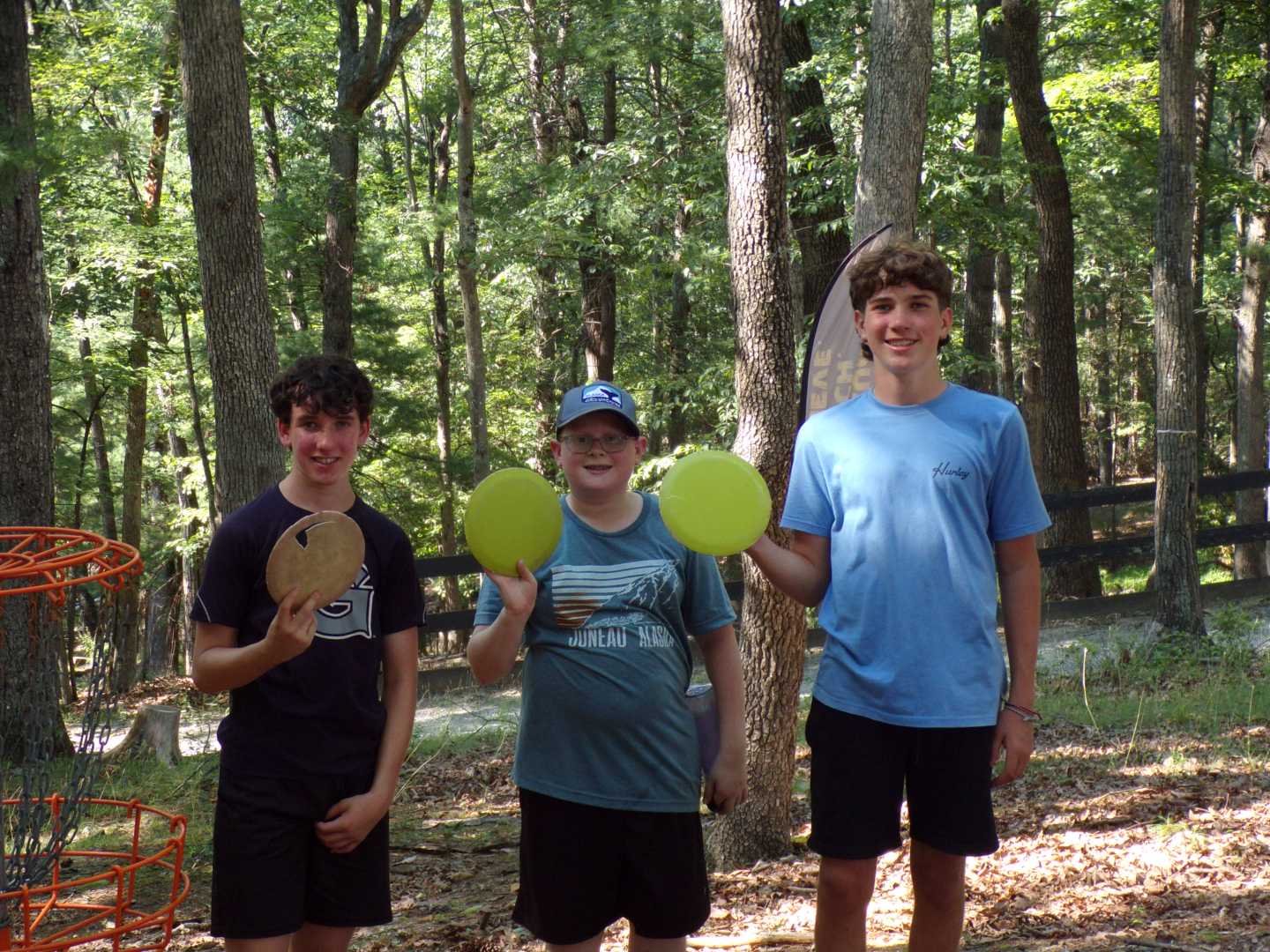 Three Camp Tall Timbers Campers holding frisbees
